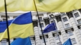 Ukraine -- Ukrainian national flags, flags of Ukrainian trade unions and EU flag are seen during a mass rally in front of the Ukrainian cabinet of ministers building in Kyiv, October 15, 2014